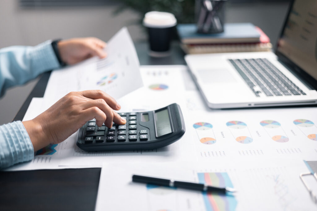 Finance bank tax expense accounting budget money businessman hand use calculator financial calculate accountant close up calculator with graph chart write office desk business expense analysis saving