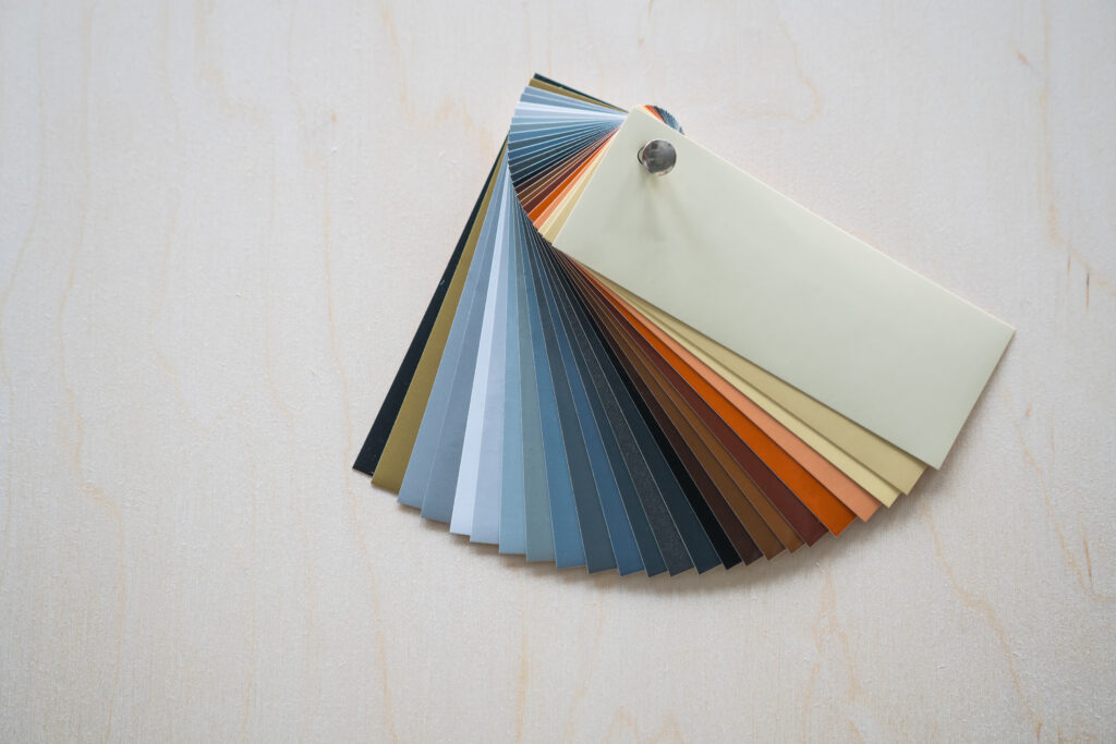 fan of adhesive vinyls in earthy neutral tones on a wooden background.