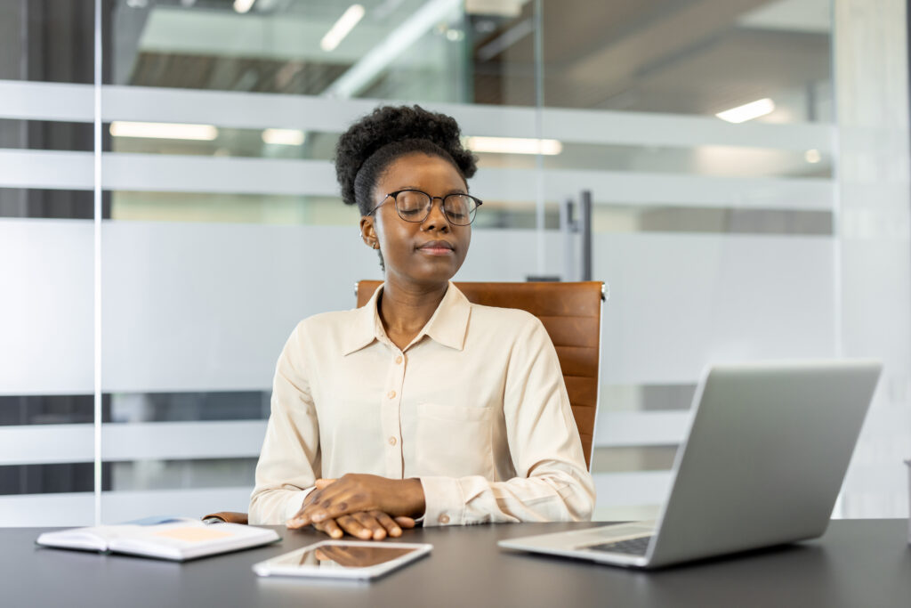 businesswoman stops to meditate during the work dat