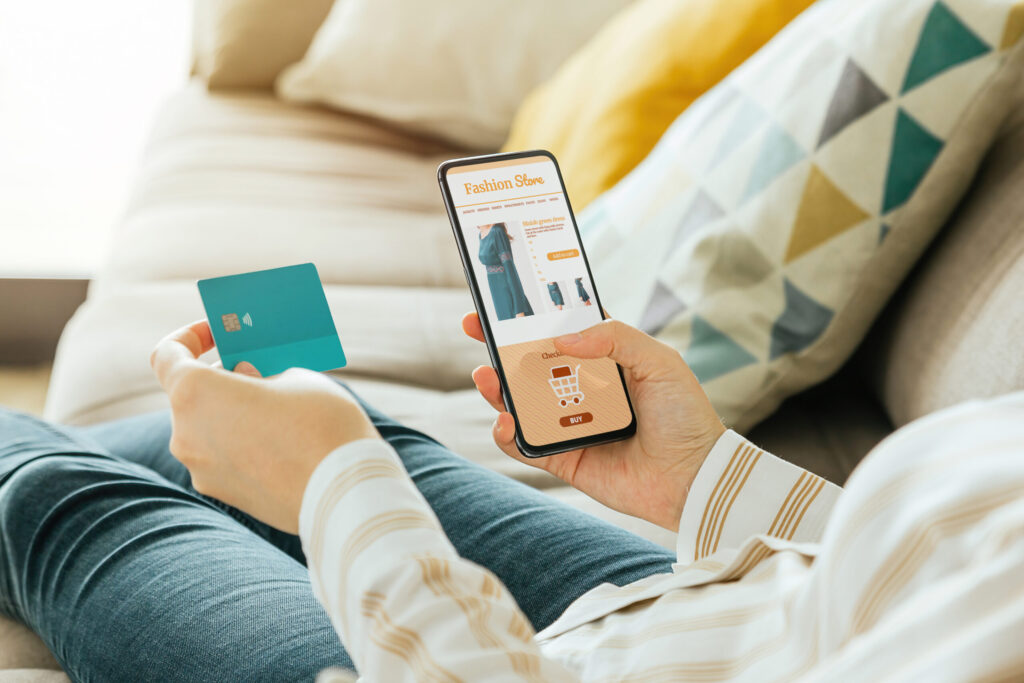 Stock photo of a woman buying a dress online with the phone and