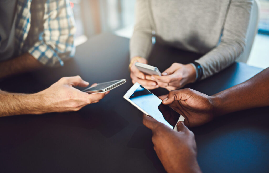 Phone, hands and people networking in circle for information, notification and online communication. closeup, group diversity and download cellphone app for contact, iot data or social media software