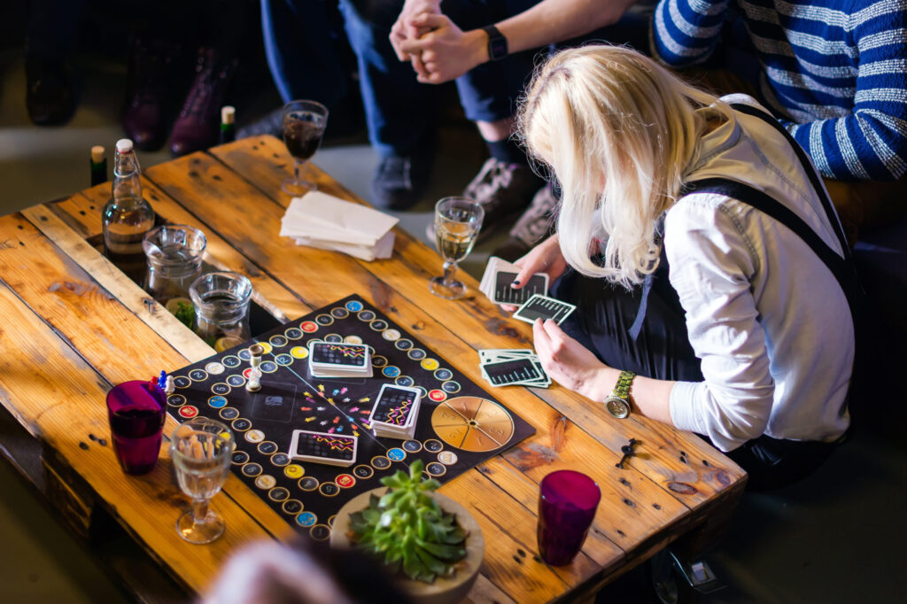 Group of young people gathered to play alias game. youth lifestyle, board games.